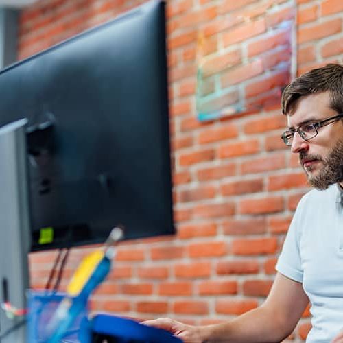 Persona investiga en su ordenador el futuro del sector TIC en España